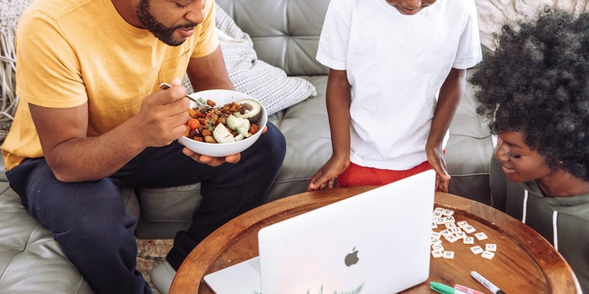 man in white crew neck t-shirt holding white ceramic bowl