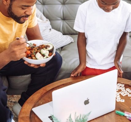 man in white crew neck t-shirt holding white ceramic bowl