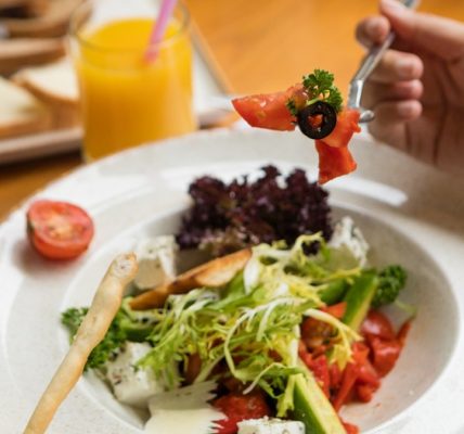 Woman eating beautiful vegetarian salad close up